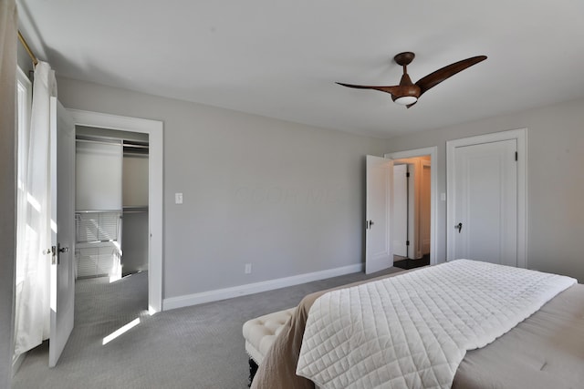 carpeted bedroom with ceiling fan and baseboards