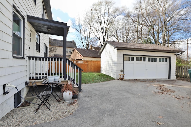 detached garage featuring fence