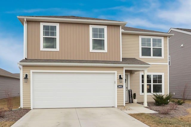 traditional-style home with a garage and driveway