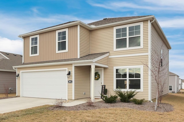 traditional-style home featuring an attached garage, concrete driveway, and roof with shingles