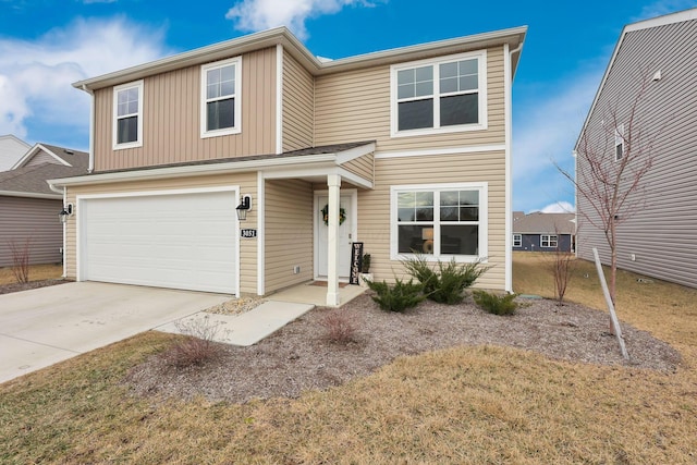 traditional-style home featuring a garage and concrete driveway