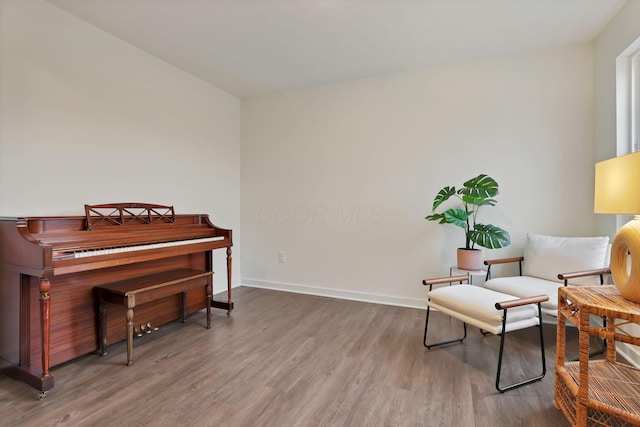 sitting room featuring baseboards and wood finished floors