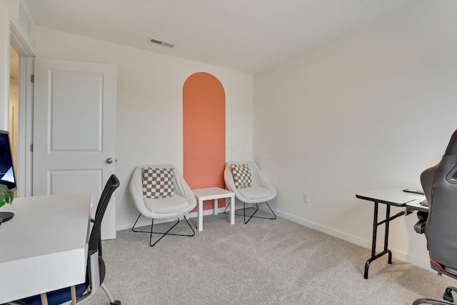 home office with arched walkways, baseboards, visible vents, and carpet flooring