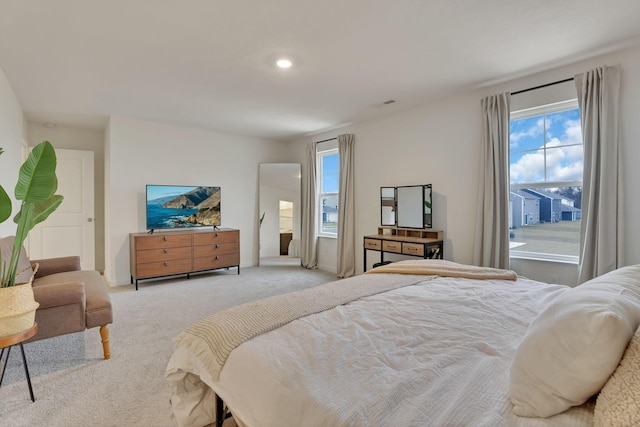 bedroom with light carpet, multiple windows, visible vents, and recessed lighting