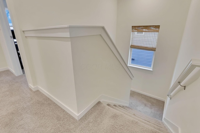 stairs featuring carpet and baseboards