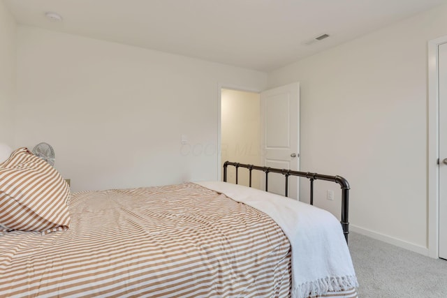 carpeted bedroom featuring baseboards