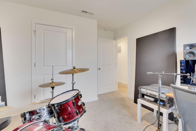 rec room with light carpet, visible vents, and baseboards