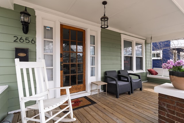 wooden terrace featuring covered porch