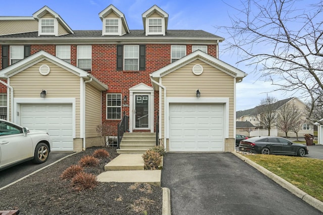 multi unit property featuring brick siding, driveway, and a shingled roof