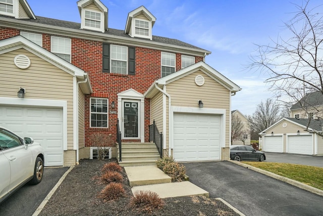 view of front facade featuring a garage, brick siding, and driveway