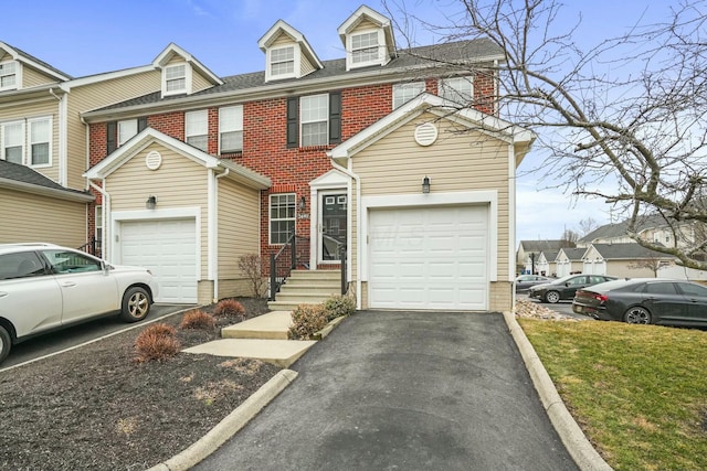 view of front of home featuring brick siding, driveway, a shingled roof, and a garage