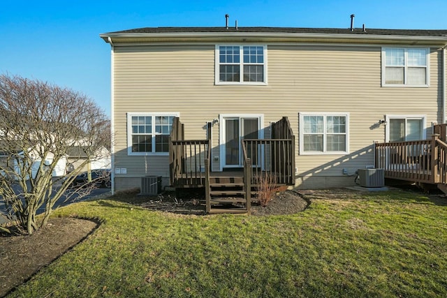 back of house with cooling unit, a yard, and a wooden deck