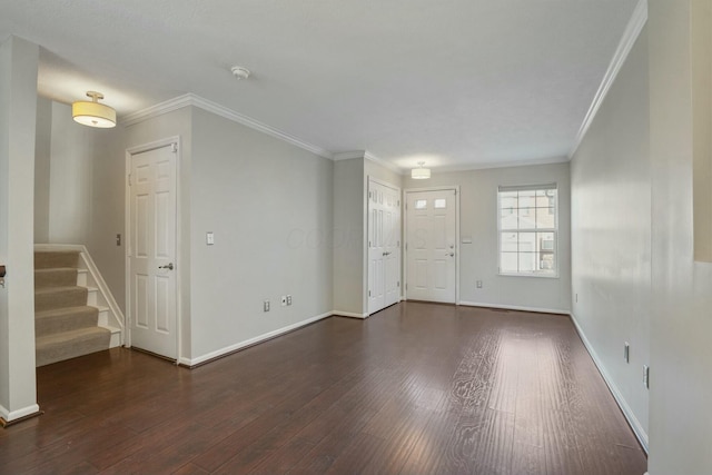 entrance foyer with stairway, wood finished floors, baseboards, and ornamental molding