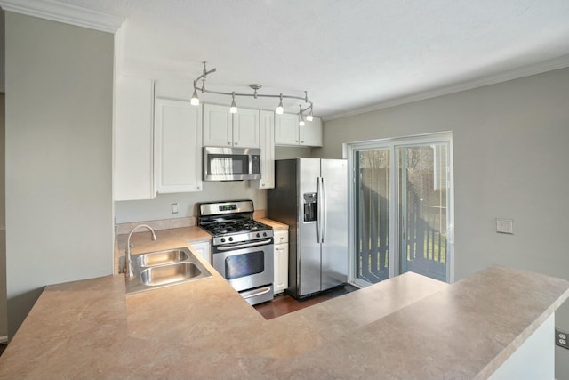 kitchen featuring white cabinetry, stainless steel appliances, crown molding, and a sink