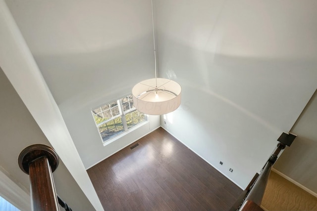 room details with visible vents, baseboards, and wood finished floors