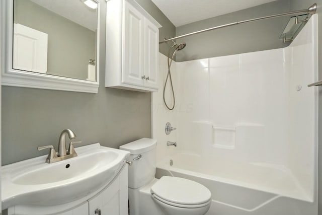 full bathroom featuring toilet, vanity, and washtub / shower combination