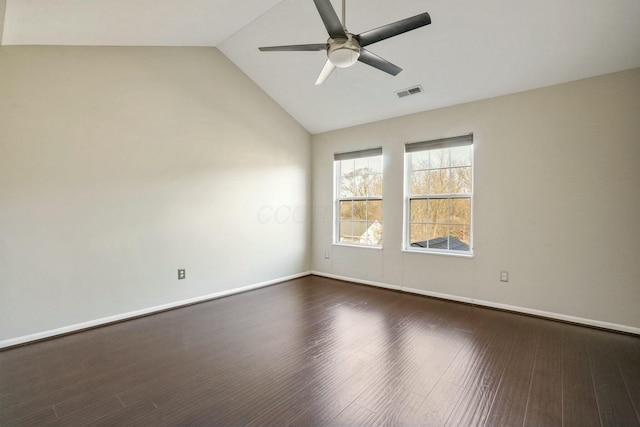 unfurnished room featuring visible vents, baseboards, vaulted ceiling, dark wood-style floors, and a ceiling fan