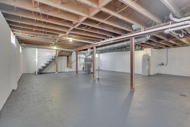 unfinished basement with water heater, heating unit, and stairs