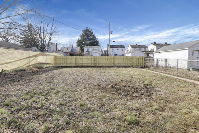 view of yard featuring a residential view and a fenced backyard