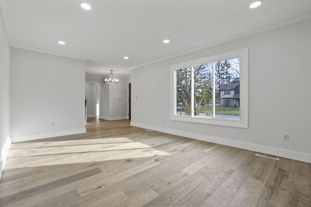 unfurnished living room with recessed lighting, wood finished floors, visible vents, and crown molding