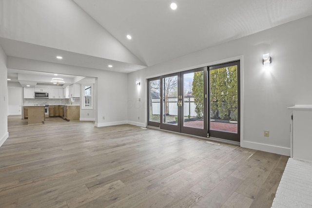 unfurnished living room featuring french doors, recessed lighting, high vaulted ceiling, light wood-type flooring, and baseboards