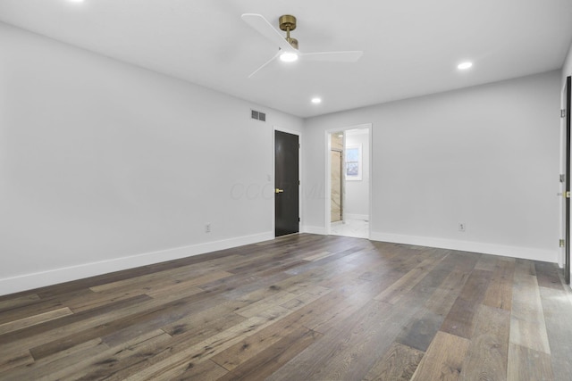 unfurnished room featuring a ceiling fan, dark wood-style flooring, visible vents, and baseboards