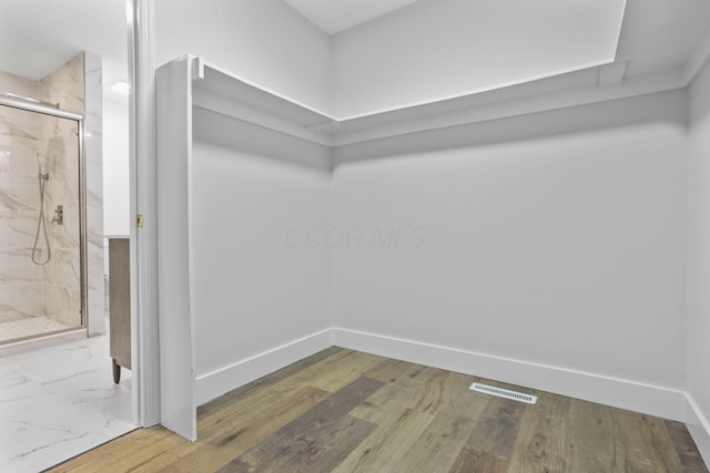 walk in closet featuring visible vents and wood finished floors