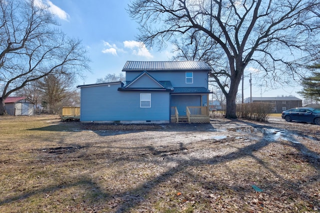 rear view of house with a deck and metal roof