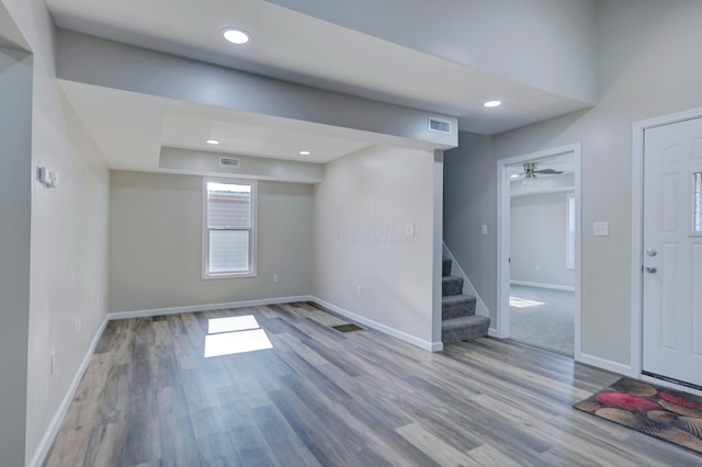 entrance foyer featuring baseboards, visible vents, wood finished floors, stairs, and recessed lighting