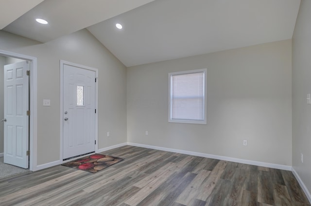 entrance foyer featuring baseboards, vaulted ceiling, wood finished floors, and recessed lighting