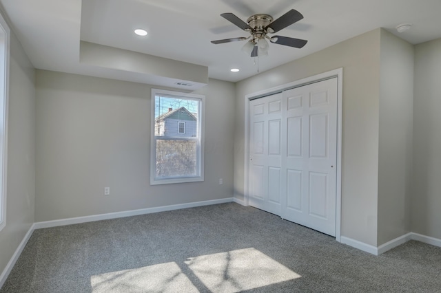 unfurnished bedroom featuring carpet floors, a closet, recessed lighting, and baseboards