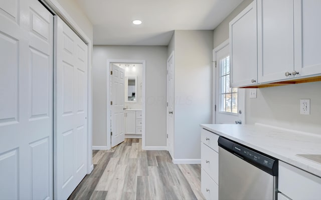 kitchen featuring baseboards, white cabinets, dishwasher, light wood-style flooring, and recessed lighting