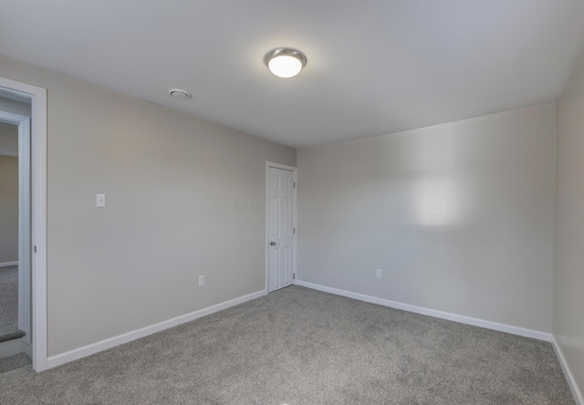 empty room with carpet and baseboards