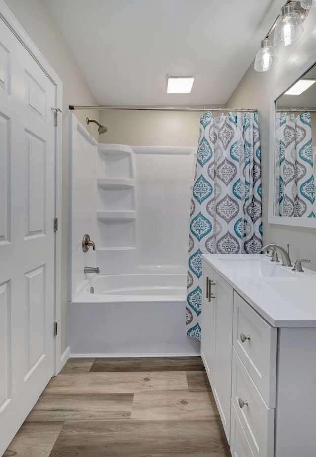 bathroom featuring shower / bath combo, wood finished floors, and vanity