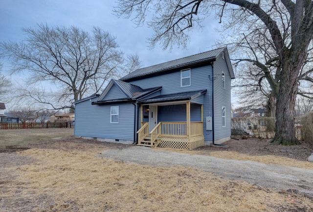 view of front of house featuring metal roof, crawl space, fence, and driveway