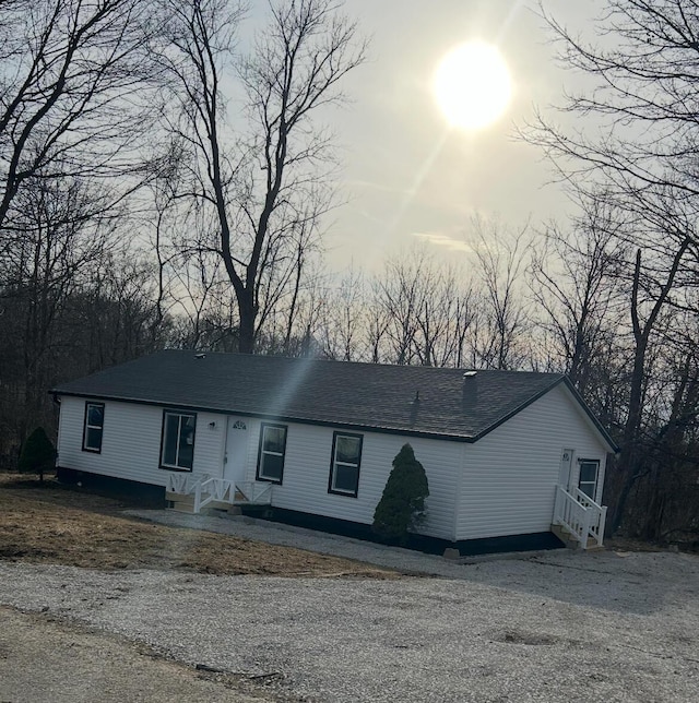 view of front of home featuring a shingled roof