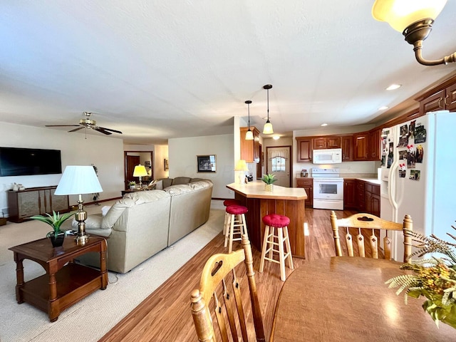 dining area with recessed lighting, ceiling fan, and light wood finished floors