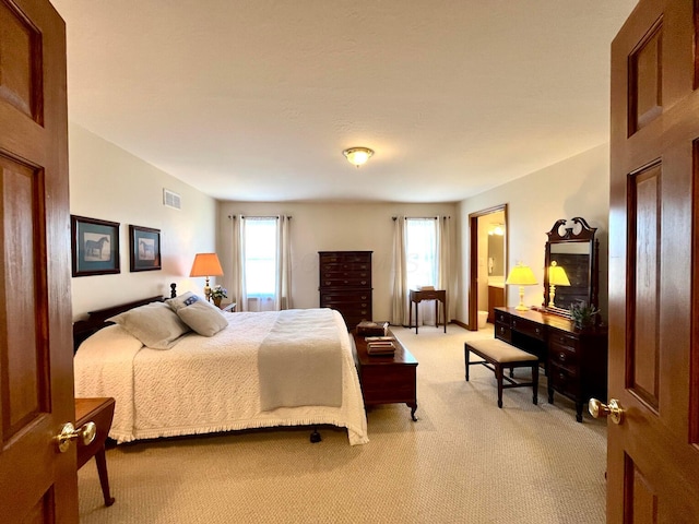 bedroom with light carpet and visible vents