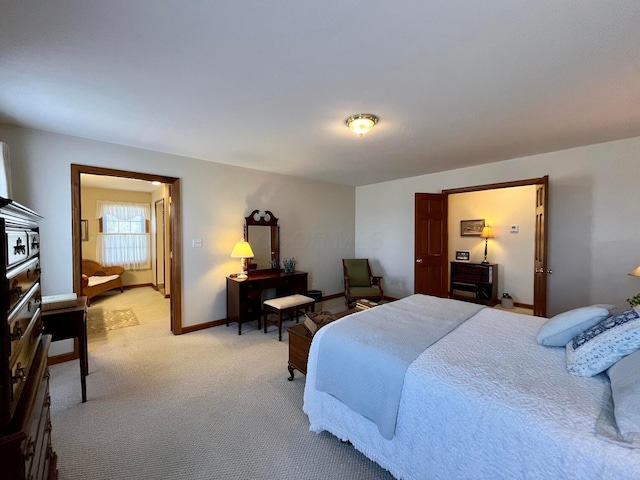 bedroom featuring light colored carpet and baseboards