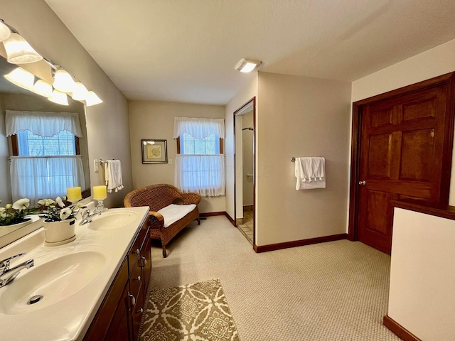 bathroom with a sink, baseboards, and double vanity