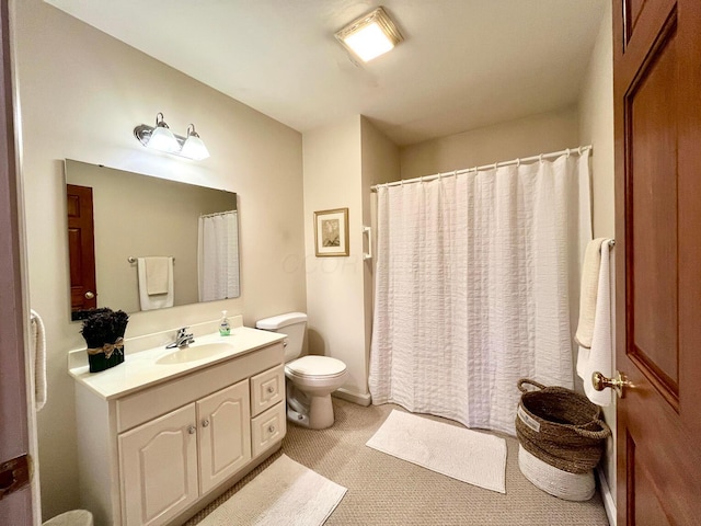 bathroom featuring toilet, vanity, and a shower with shower curtain