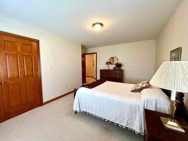 carpeted bedroom featuring baseboards