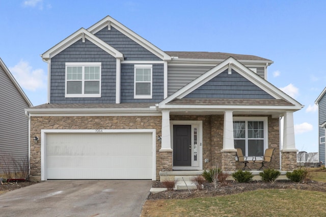 craftsman house with driveway, an attached garage, and a porch