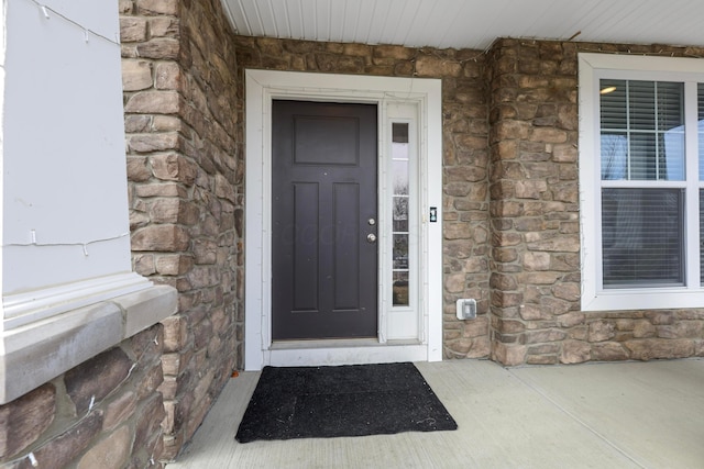 property entrance with stone siding