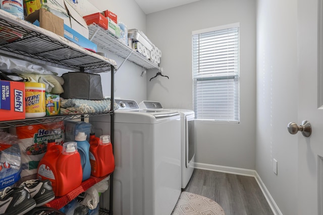 laundry room with laundry area, independent washer and dryer, baseboards, and wood finished floors