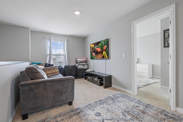 carpeted living area featuring baseboards