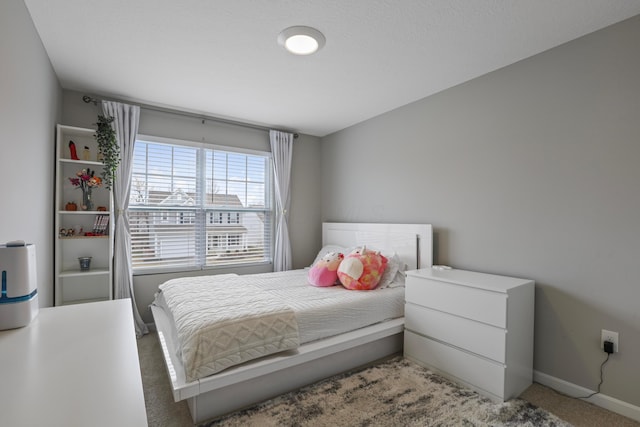 bedroom with carpet floors and baseboards