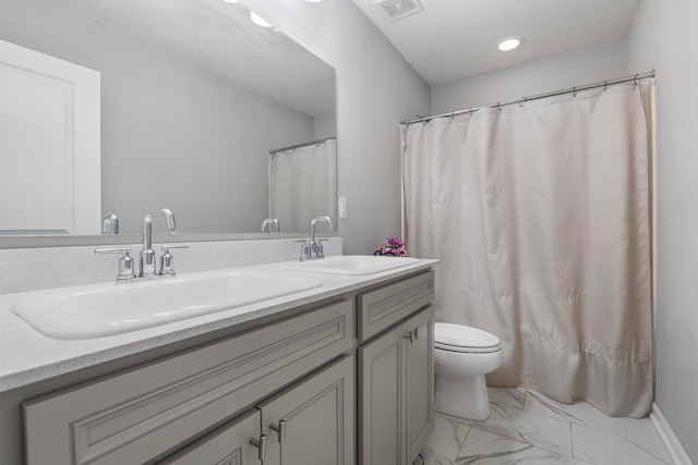 full bathroom featuring toilet, marble finish floor, visible vents, and a sink