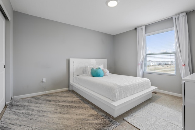 carpeted bedroom featuring baseboards