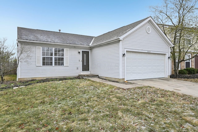 single story home featuring a front yard, concrete driveway, and an attached garage